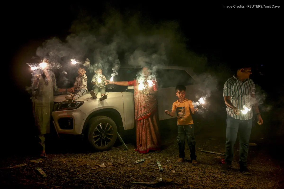 family celebrating diwali with fireworks